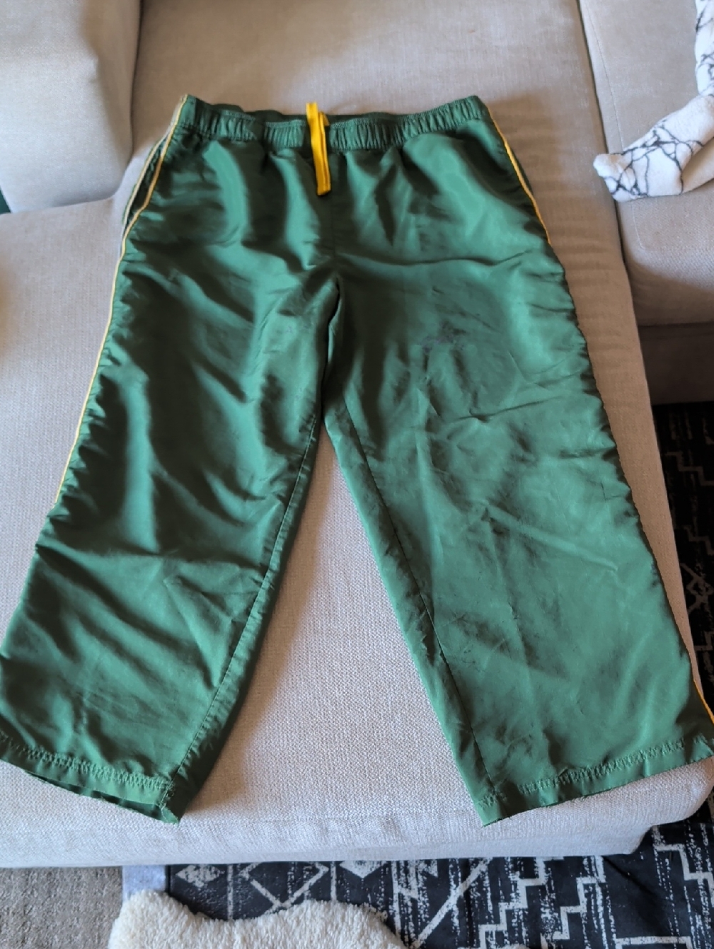 Green Athletic Pants with Yellow Stripes